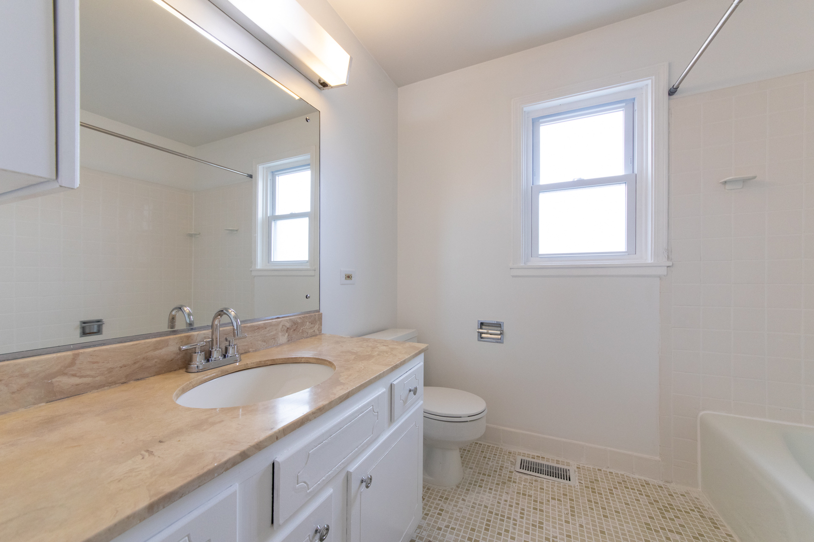 2148 Rugen Road, Unit B Glenview, IL 60026 - Photo 13 of 23 a bathroom with a granite countertop sink a toilet and a window
