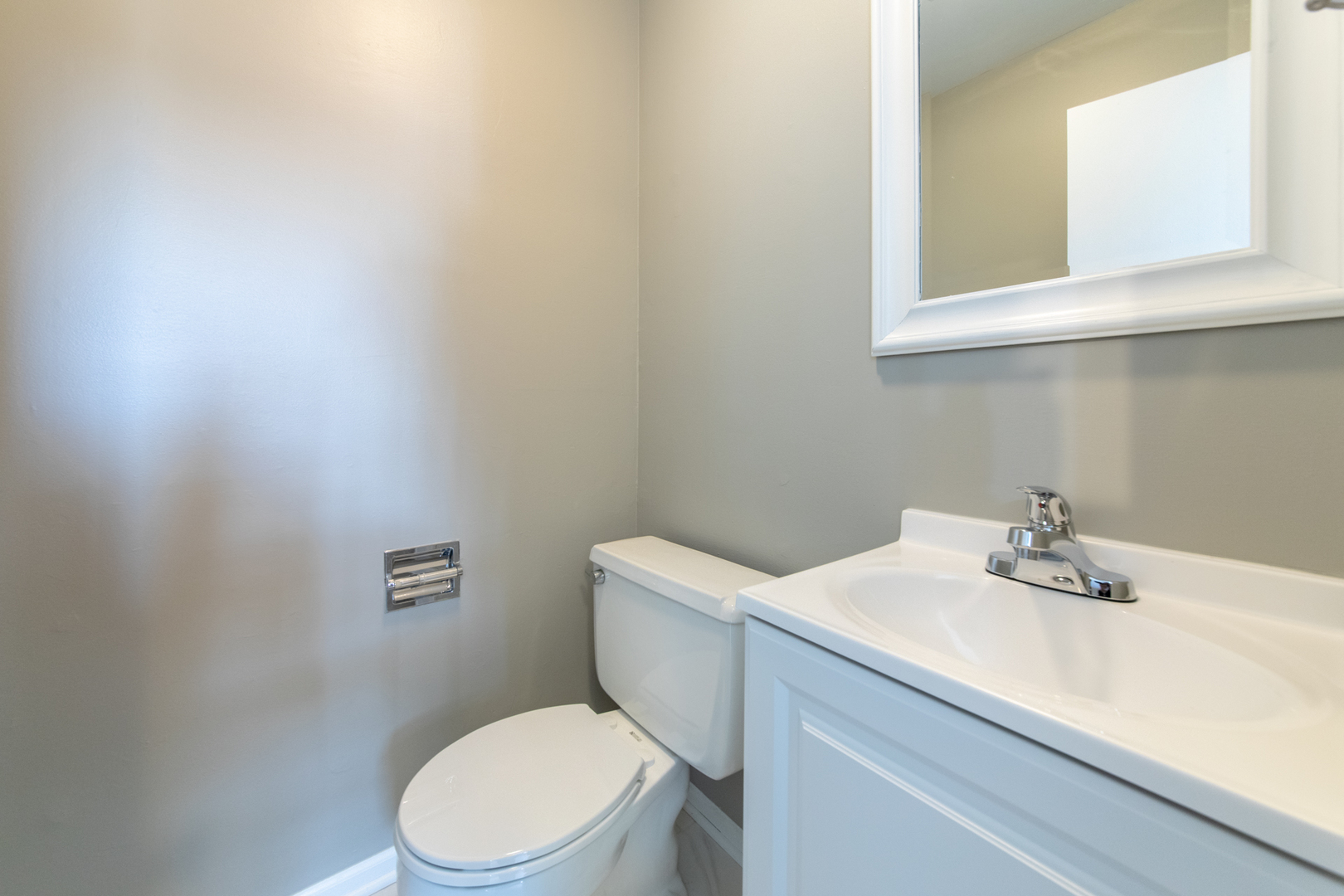 2148 Rugen Road, Unit B Glenview, IL 60026 - Photo 17 of 23 a bathroom with a sink a toilet and a mirror