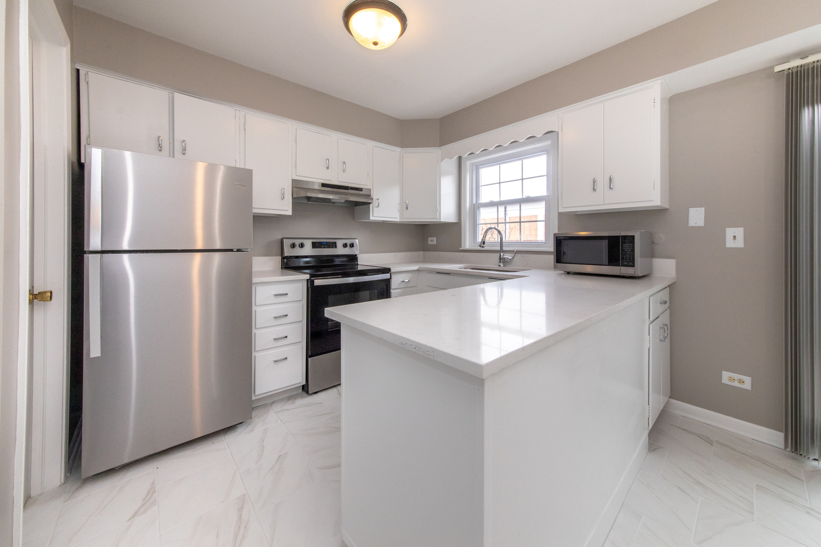 2148 Rugen Road, Unit B Glenview, IL 60026 - Photo 8 of 23 a kitchen with a refrigerator a stove top oven a sink and cabinets