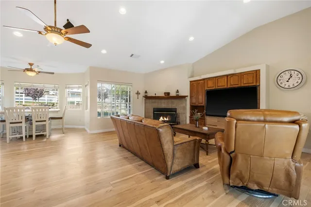 a kitchen with a sink dishwasher a fireplace with wooden cabinets and dining table