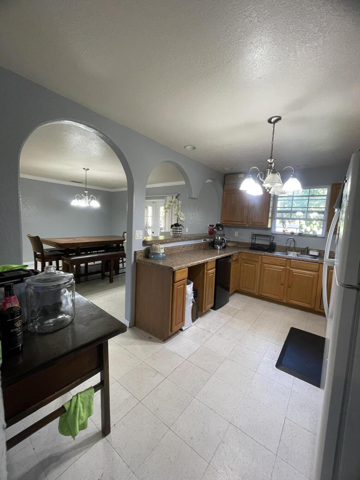 1220 A Road LaBelle, FL 33935 - Photo 15 of 42 a kitchen with stainless steel appliances granite countertop a stove a sink and a microwave