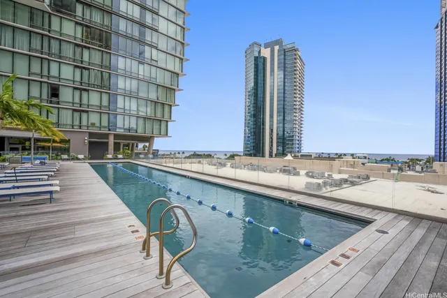 a view of swimming pool with outdoor seating and wooden floor
