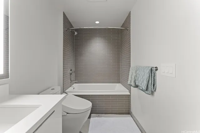 a bathroom with a shower a toilet and sink