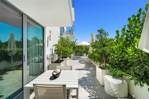 a view of a balcony with chair and potted plants