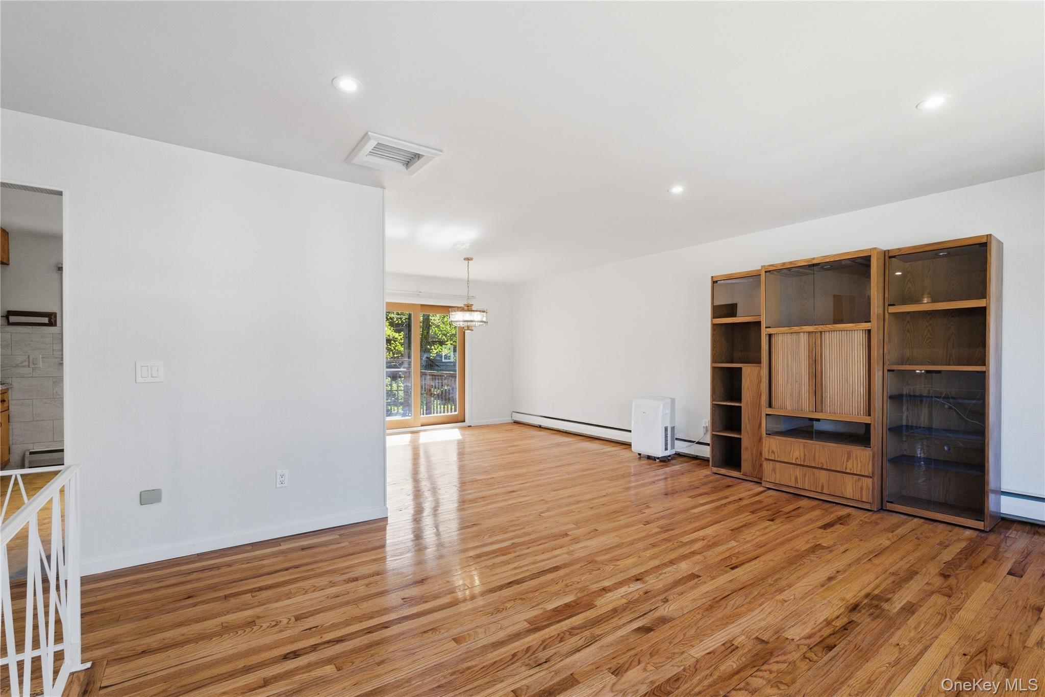 400 South Little Tor Road New City, NY 10956 - Photo 3 of 18 L-Shaped Living Room and Dining Room with Slider to Deck and Hardwood Floors