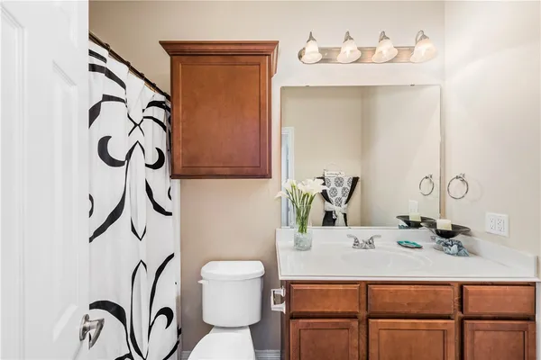 a bathroom with a sink vanity and a mirror
