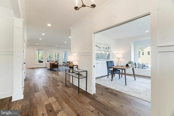 a view of a a dining room with furniture window and wooden floor