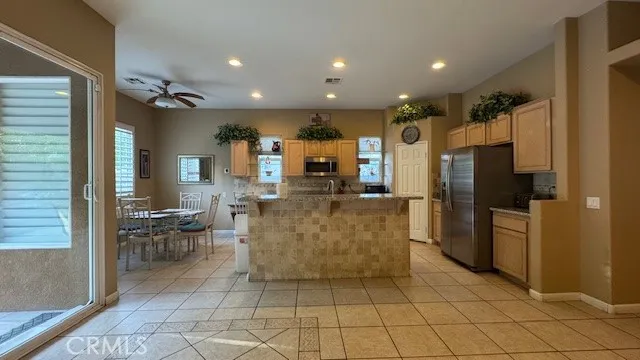 a large kitchen with a table and chairs