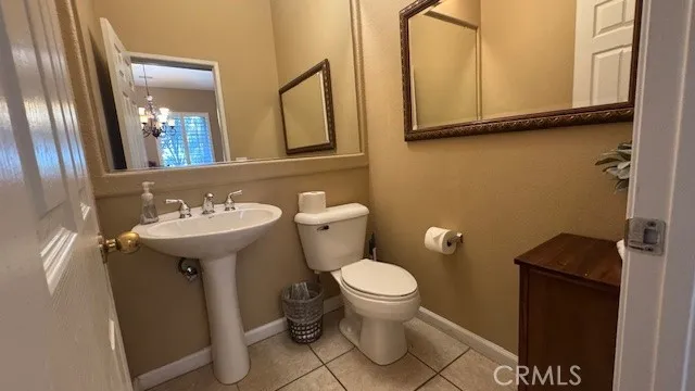 a bathroom with a sink toilet and mirror