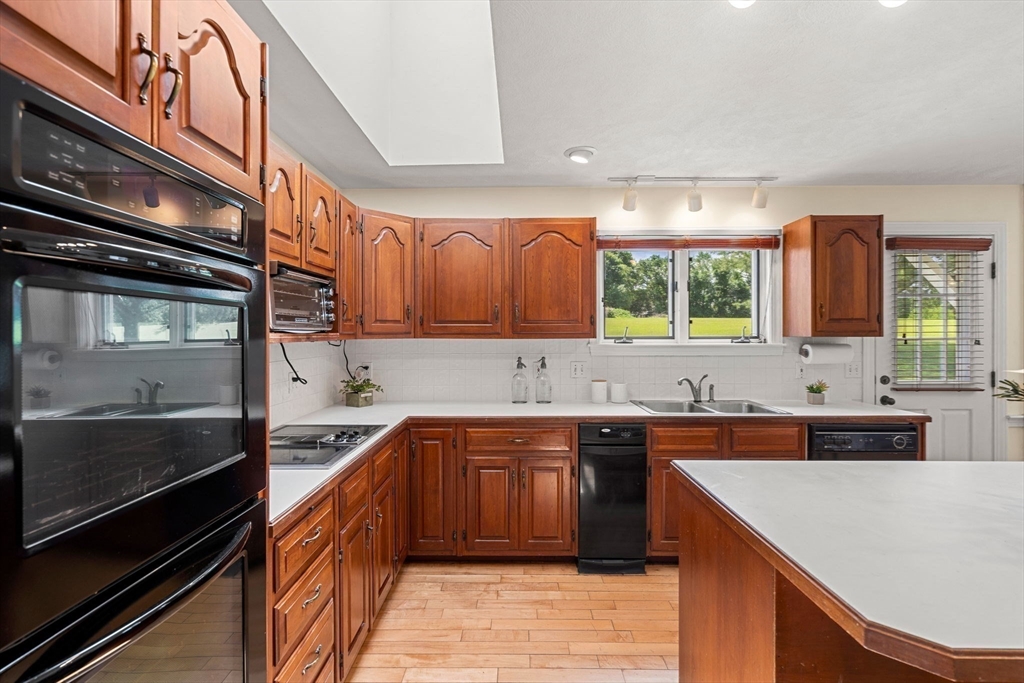 61 Turkey Hill Road West Newbury, MA 01985 - Photo 11 of 42 a kitchen with a sink a stove and cabinets