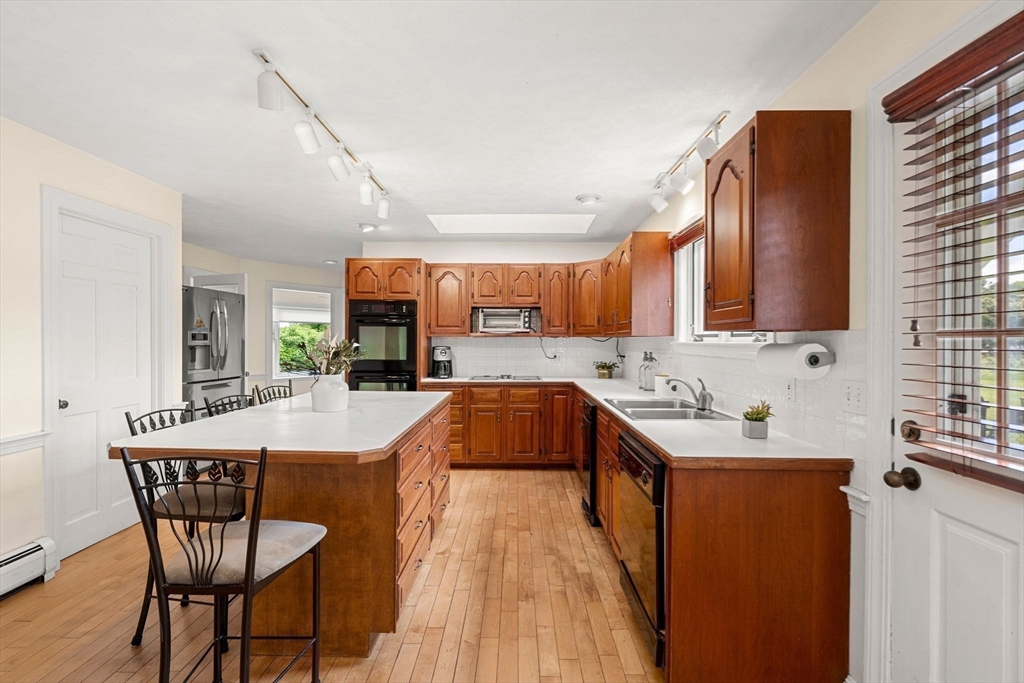 61 Turkey Hill Road West Newbury, MA 01985 - Photo 12 of 42 a kitchen with stainless steel appliances a sink cabinets and wooden floor