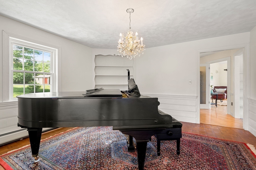 61 Turkey Hill Road West Newbury, MA 01985 - Photo 13 of 42 a living room with furniture and a chandelier