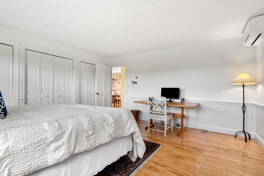 61 Turkey Hill Road West Newbury, MA 01985 - Photo 22 of 42 a bedroom with a bed and a table chair