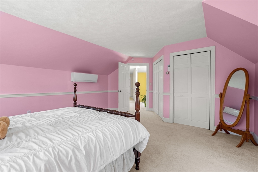 61 Turkey Hill Road West Newbury, MA 01985 - Photo 34 of 42 a bedroom with a bed and a mirror