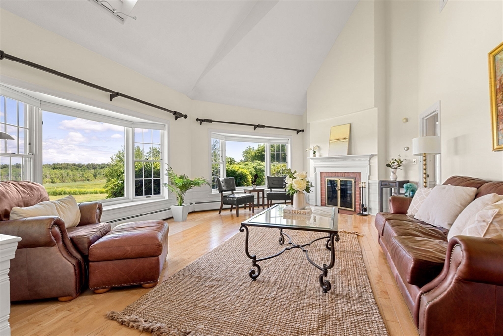 61 Turkey Hill Road West Newbury, MA 01985 - Photo 5 of 42 a living room with furniture fireplace and floor to ceiling windows