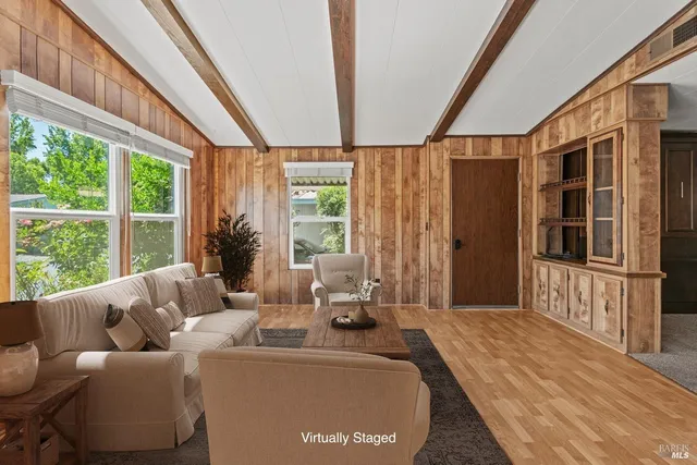 a living room with furniture and large windows