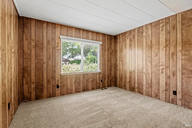 an empty room with windows and curtain