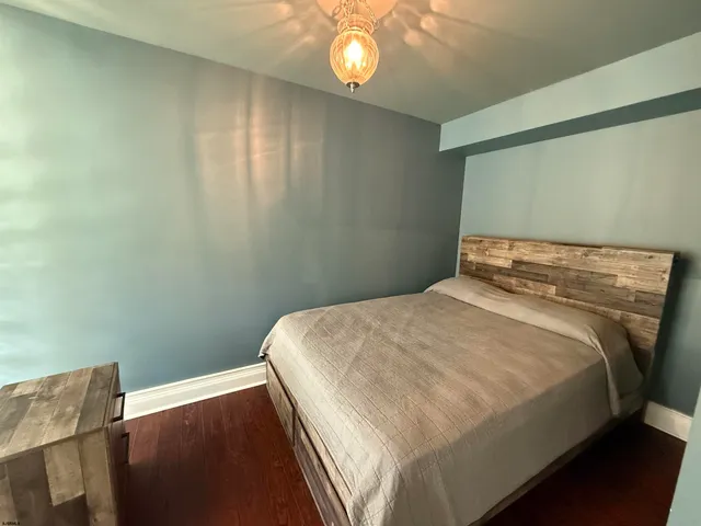 a bedroom with a bed and lamp