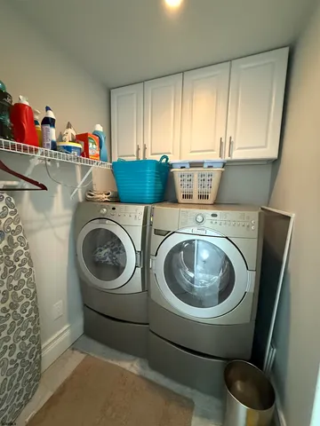a utility room with sink washer and dryer