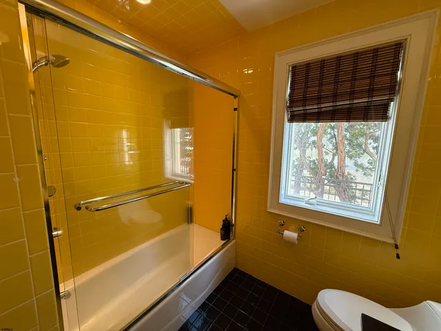 a bathroom with a bathtub and shower