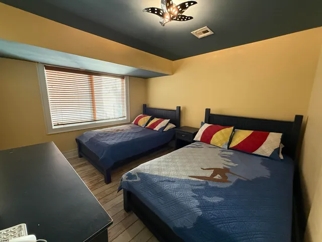 a bedroom with a bed and window