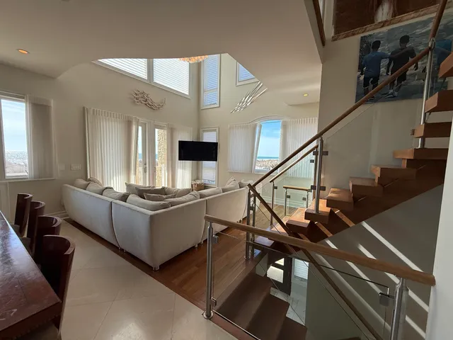 a living room with furniture and stairs