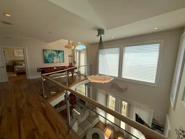 a bedroom with a large bed and a wooden floor