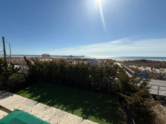 a view of a balcony with mountain view and wooden floor