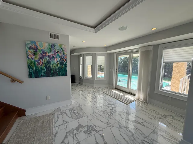 a view of a room with window and hardwood floor