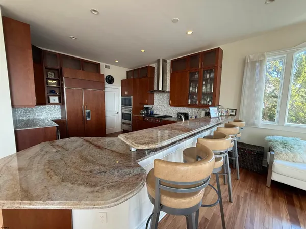 a kitchen with kitchen island granite countertop a sink and stove