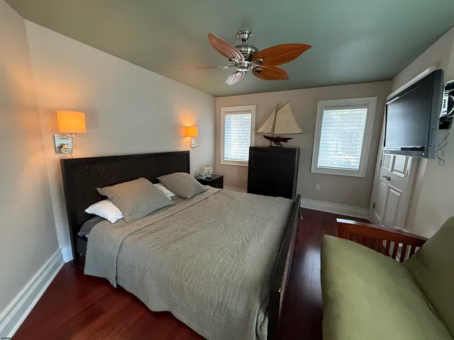 a bedroom with a bed mirror and window