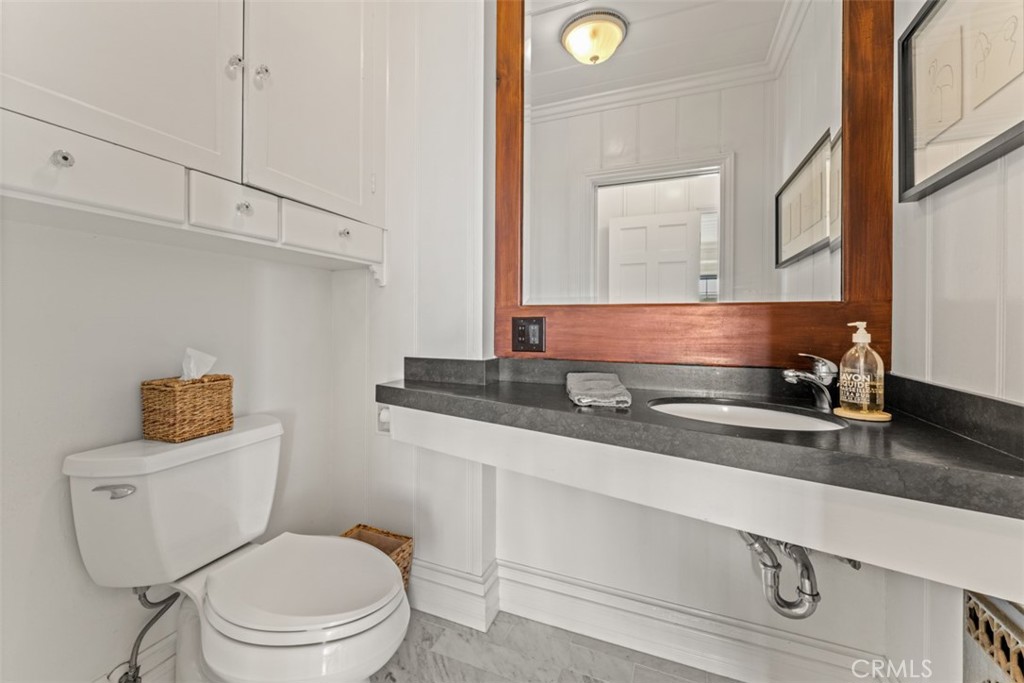 500 Mountain Road Laguna Beach, CA 92651 - Photo 17 of 36 a bathroom with a toilet a sink and mirror