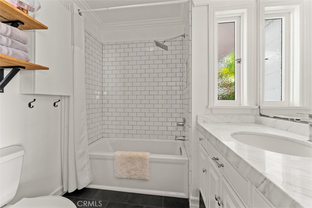 500 Mountain Road Laguna Beach, CA 92651 - Photo 20 of 36 a bathroom with a granite countertop bathtub a sink a toilet and shower