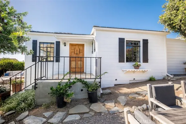 a view of backyard of house with seating space