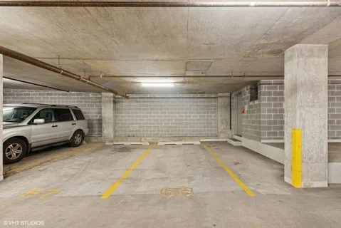 a view of parking garage with cars parked