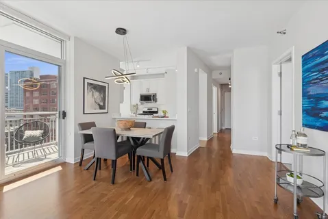 a view of a dining room with furniture and wooden floor