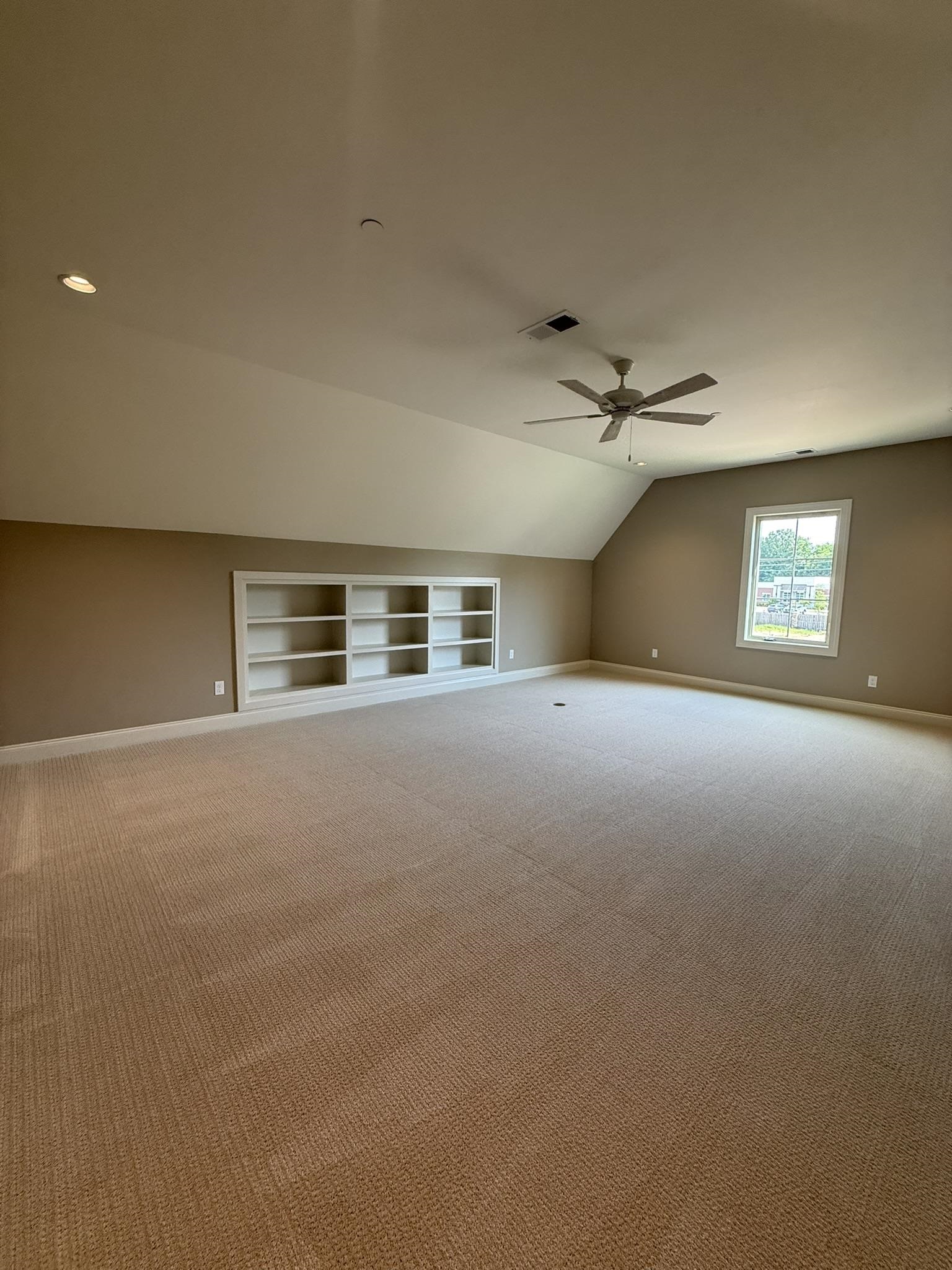 10132 Rokeby Farm Lane Collierville, TN 38017 - Photo 21 of 24 Spacious carpeted room featuring a ceiling fan, recessed lighting, and built-in shelving