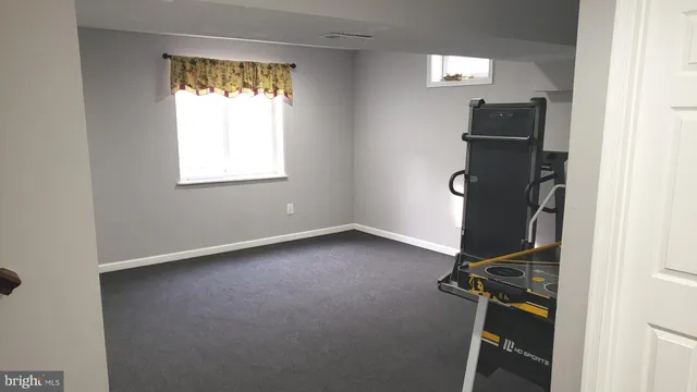 a room with gym equipment and a window