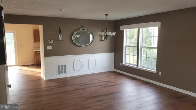 a view of a room with wooden floor and window