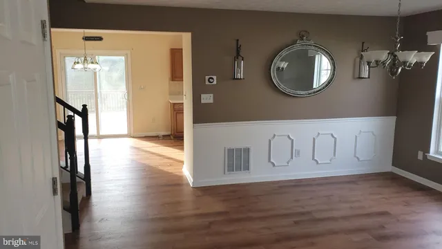 a view of a entryway door with wooden floor