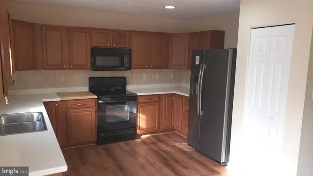a kitchen with a refrigerator sink and microwave
