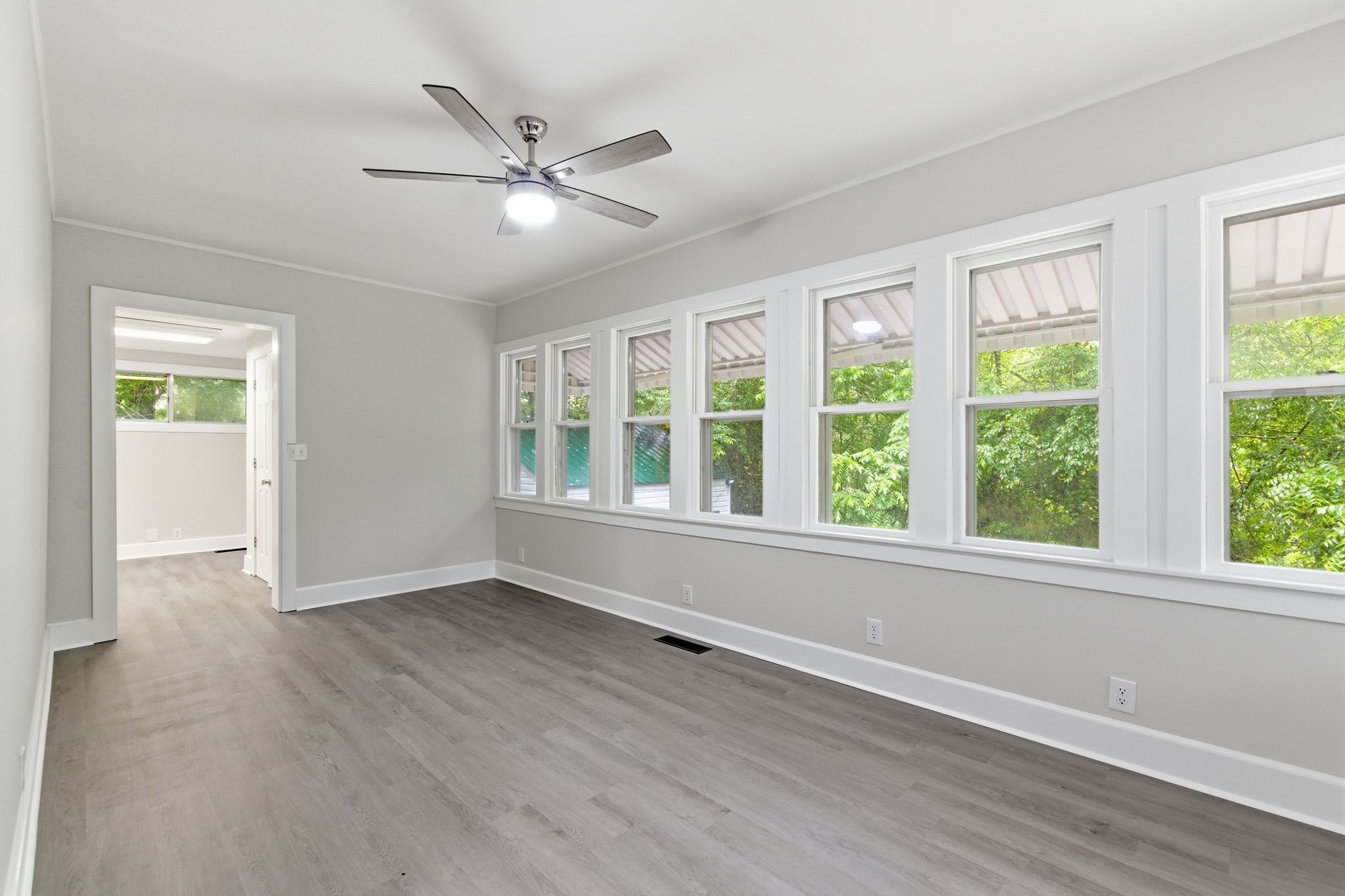 305 South Irwin Street Manchester, TN 37355 - Photo 17 of 40 a view of an empty room with wooden floor and a window