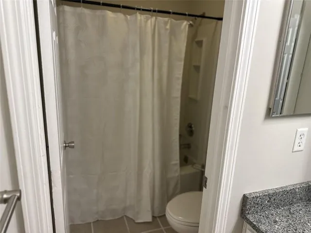 an empty room with fan and windows