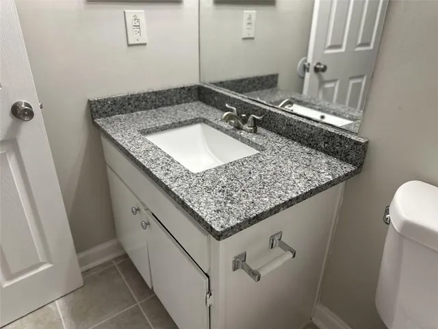 a white toilet sitting next to a shower curtain