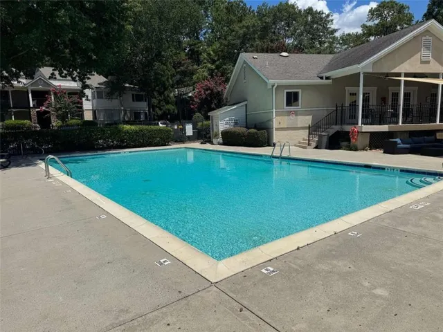 a front view of a house with a yard table and chairs