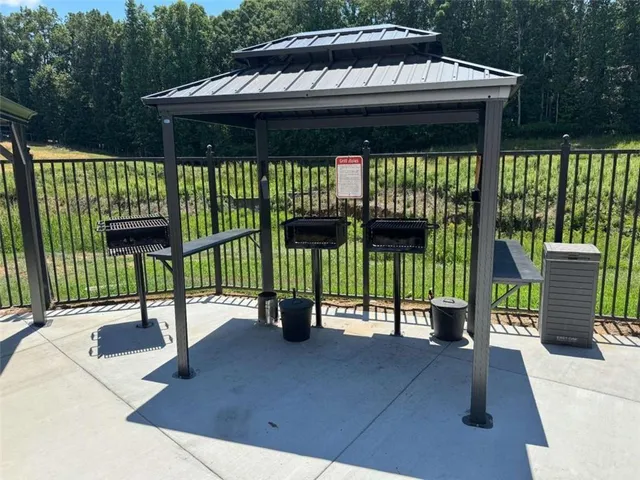 a view of a roof deck with table and chairs