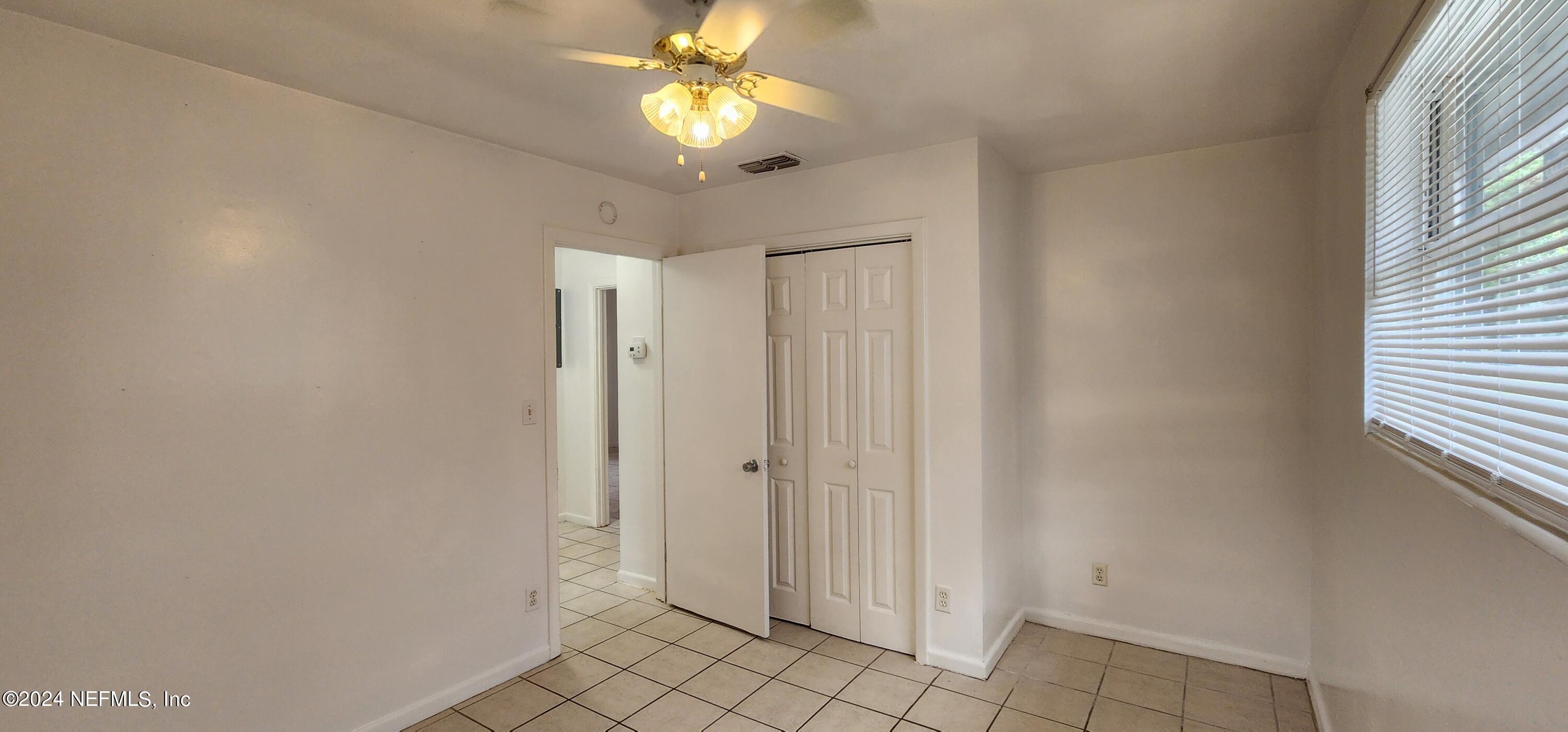5968 110th Street Jacksonville, FL 32244 - Photo 7 of 13 a view of a chandelier fan and entryway