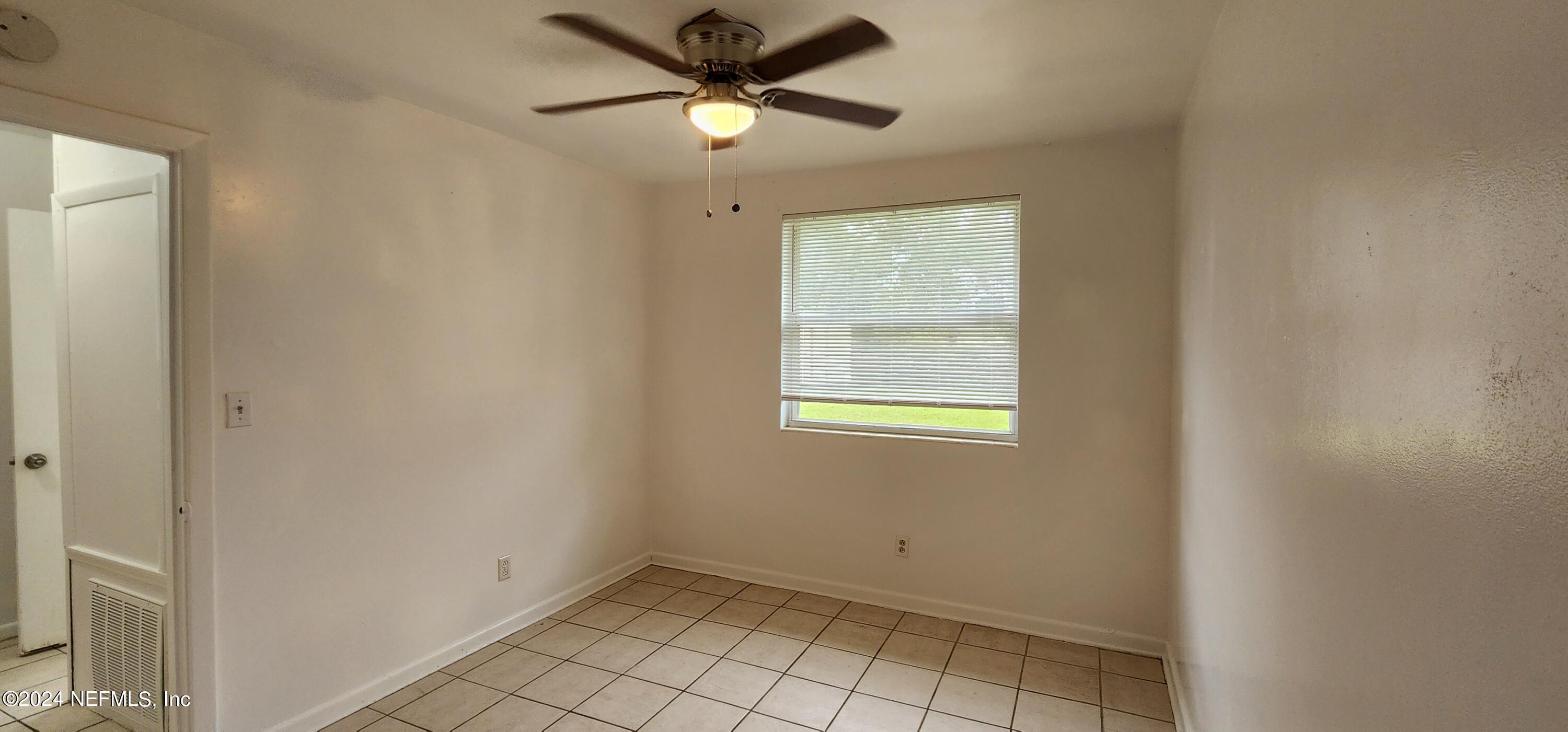 5968 110th Street Jacksonville, FL 32244 - Photo 8 of 13 a view of an empty room with a window
