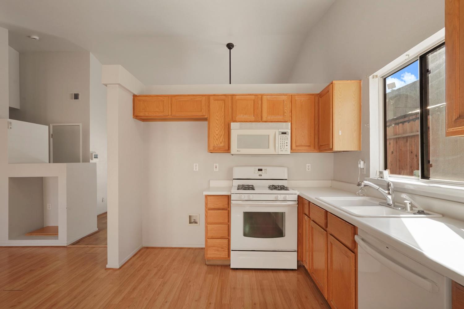 2449 Calvert Street Stockton, CA 95210 - Photo 13 of 37 a kitchen with stainless steel appliances a stove a sink and a microwave