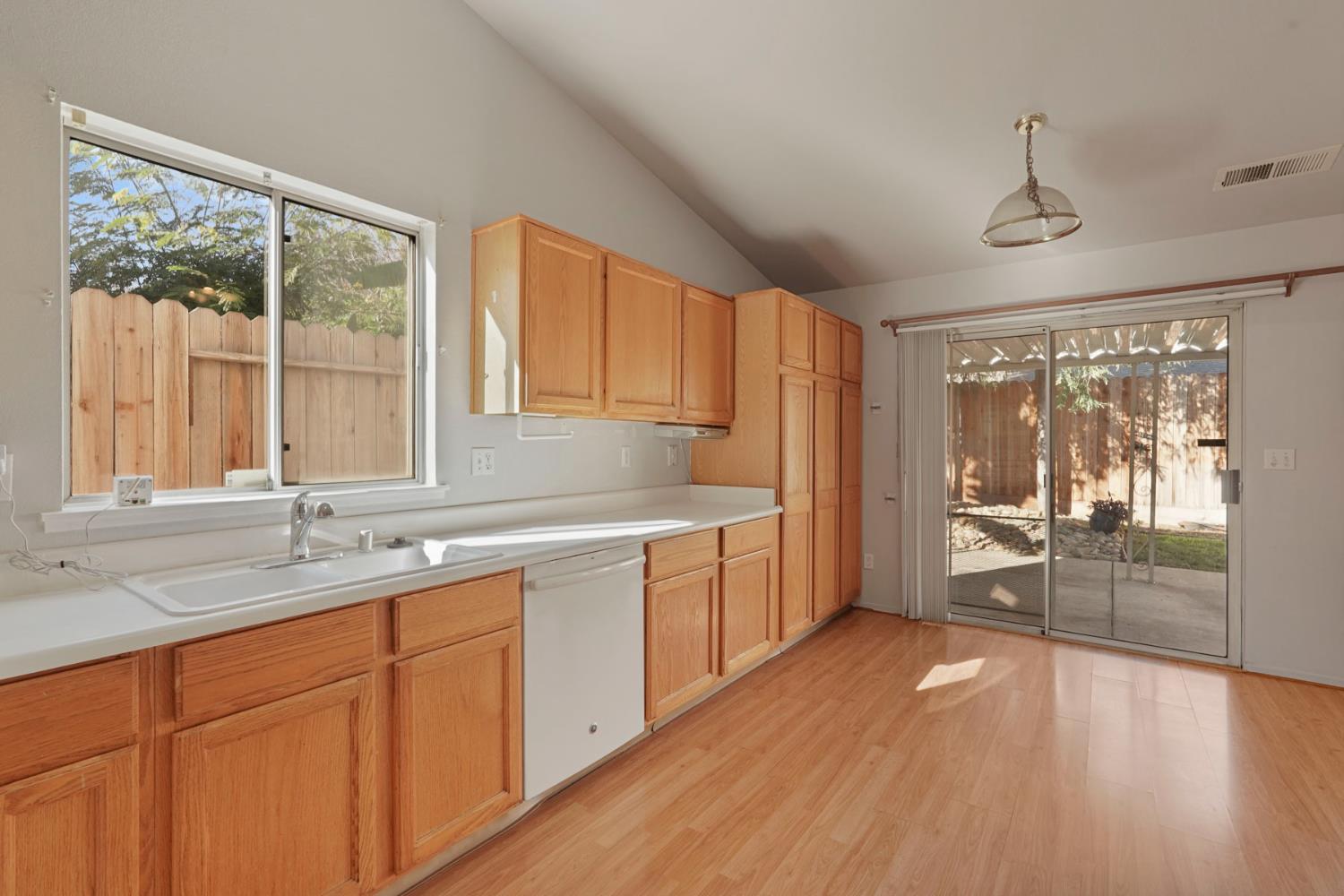 2449 Calvert Street Stockton, CA 95210 - Photo 14 of 37 a kitchen with a sink and wooden cabinets